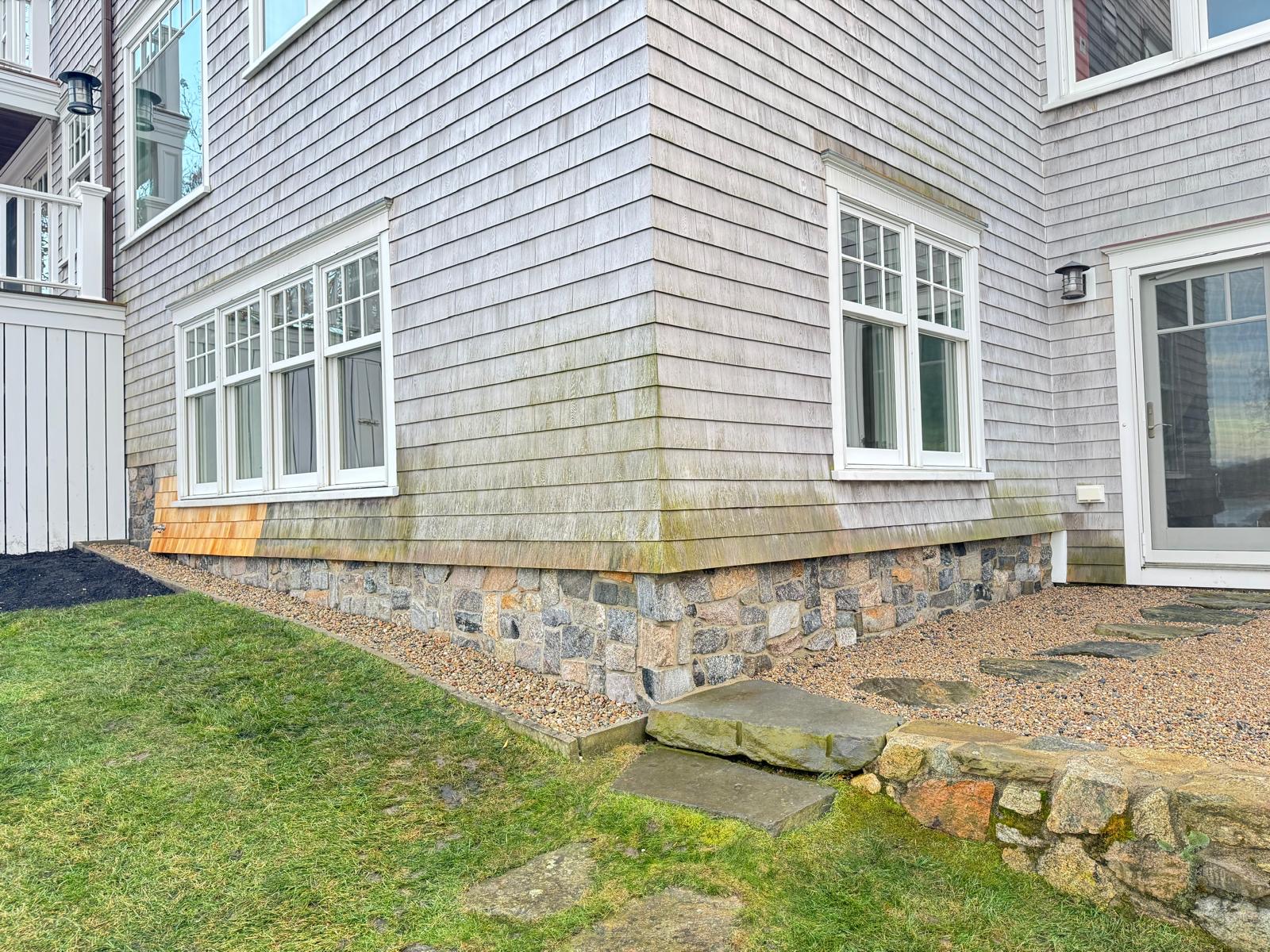 Home with stone veneer foundation and bluestone step by Solid Stone Masonry